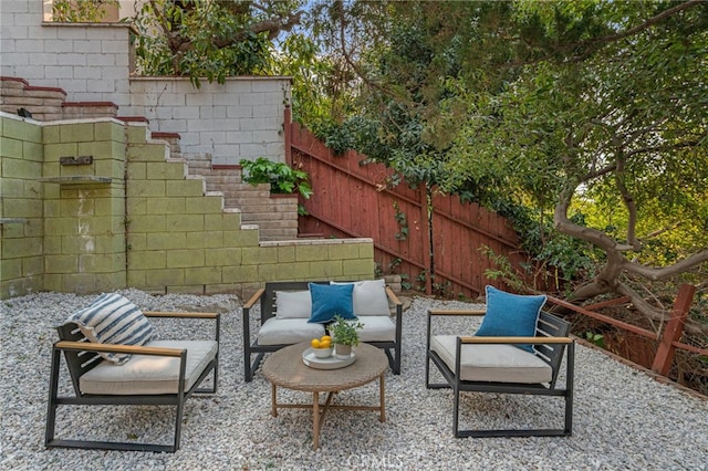 view of patio featuring fence and an outdoor hangout area