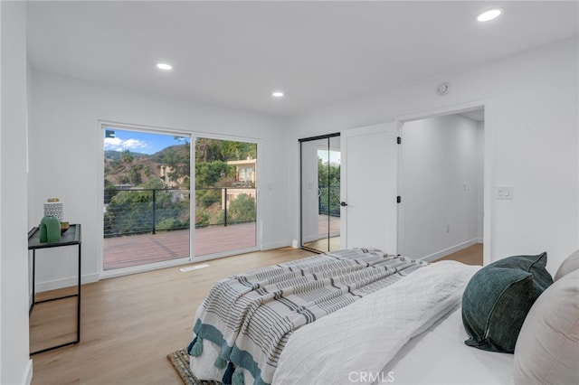 bedroom featuring access to exterior, light wood finished floors, recessed lighting, and baseboards