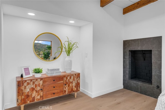 hall featuring recessed lighting, baseboards, beam ceiling, and wood finished floors