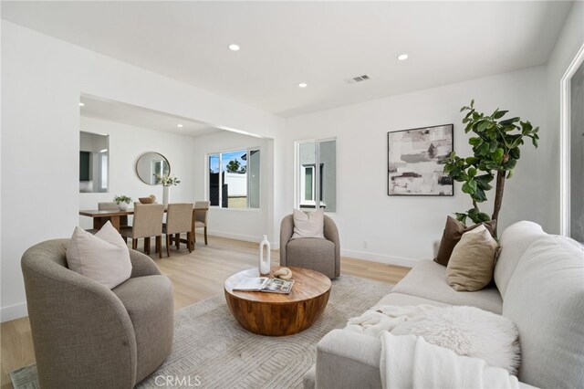 3533 Deerford St, Lakewood, CA 90712 - living area with light wood-style flooring, baseboards, visible vents, and recessed lighting