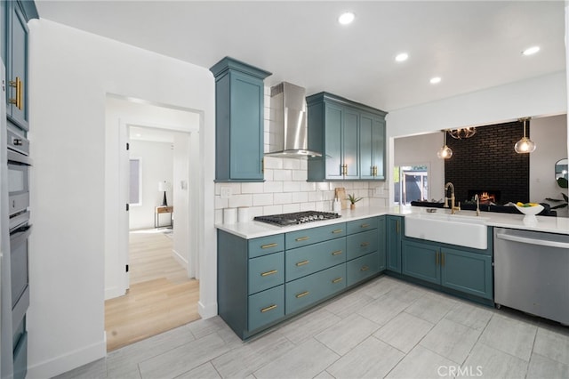 3533 Deerford St, Lakewood, CA 90712 - kitchen with wall chimney exhaust hood, a sink, light countertops, appliances with stainless steel finishes, and decorative backsplash