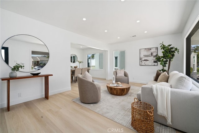 3533 Deerford St, Lakewood, CA 90712 - living room with light wood-style floors, baseboards, visible vents, and recessed lighting