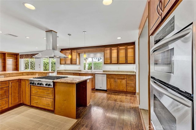 25 Bennington, Irvine, CA 92620 - kitchen featuring island range hood, visible vents, appliances with stainless steel finishes, and brown cabinets