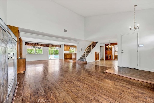 25 Bennington, Irvine, CA 92620 - interior space featuring a towering ceiling, visible vents, a chandelier, stairs, and hardwood / wood-style flooring