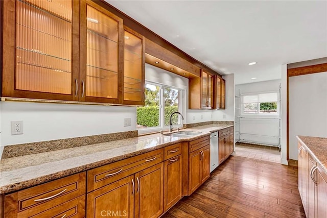 25 Bennington, Irvine, CA 92620 - kitchen with brown cabinets, dishwasher, a sink, and light stone countertops