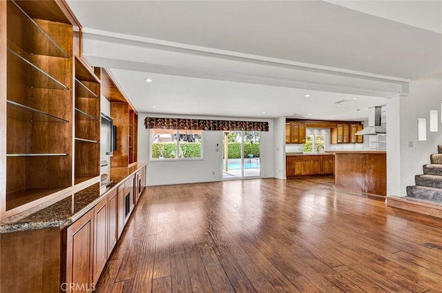 25 Bennington, Irvine, CA 92620 - unfurnished living room with dark wood-style flooring, recessed lighting, stairs, and a sink