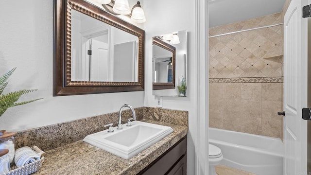 bathroom with toilet, shower / tub combination, and vanity