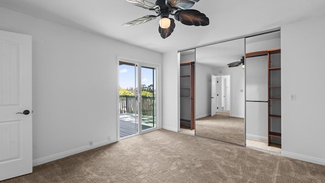 unfurnished bedroom featuring access to outside, carpet flooring, and baseboards