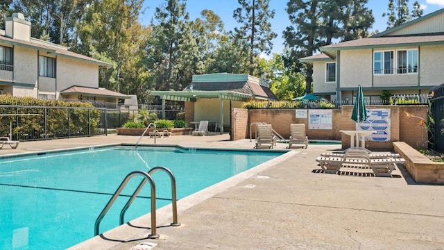 pool featuring a patio and fence