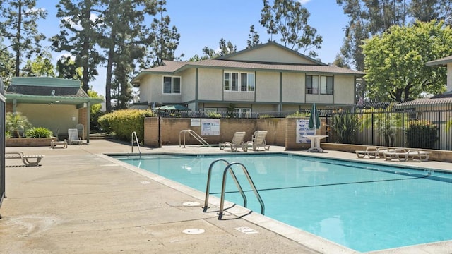 pool featuring a patio area and fence