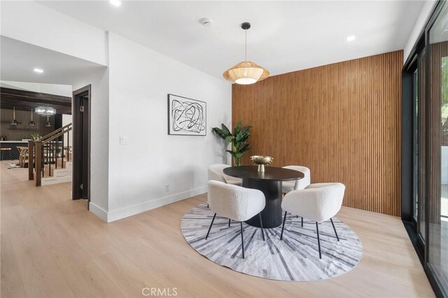 115 Buckskin Rd, Bell Canyon, CA 91307 - dining room with wood finished floors, wooden walls, baseboards, and an accent wall