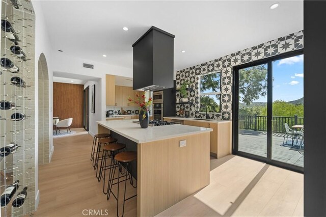 115 Buckskin Rd, Bell Canyon, CA 91307 - kitchen featuring a sink, light countertops, a kitchen bar, light wood-type flooring, and a center island