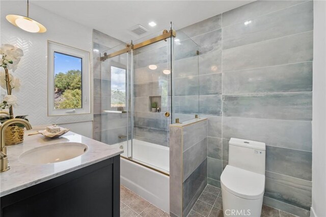 115 Buckskin Rd, Bell Canyon, CA 91307 - bathroom featuring shower / bath combination with glass door, tile walls, vanity, and toilet