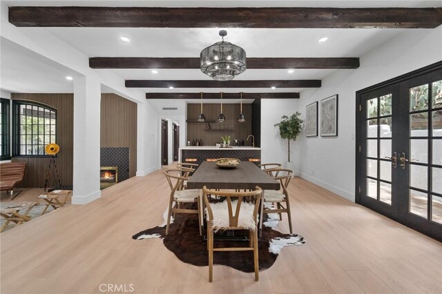 115 Buckskin Rd, Bell Canyon, CA 91307 - dining room featuring light wood-type flooring, baseboards, a warm lit fireplace, beam ceiling, and recessed lighting