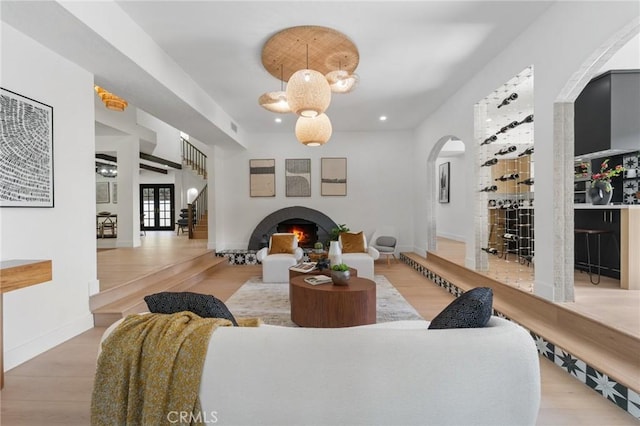 115 Buckskin Rd, Bell Canyon, CA 91307 - living area with arched walkways, a fireplace, wood finished floors, and baseboards