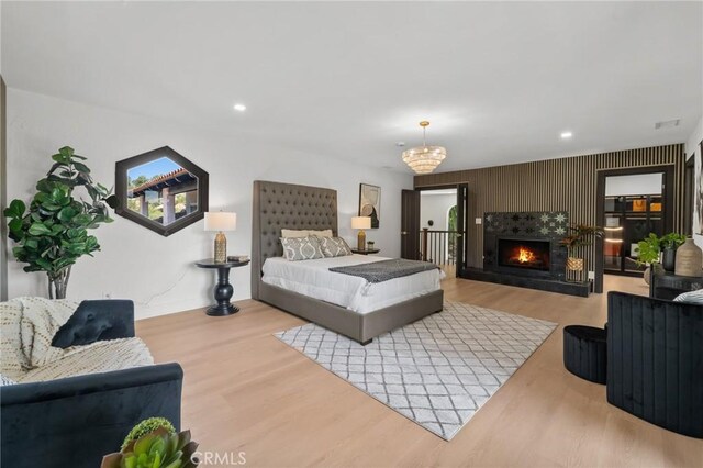 115 Buckskin Rd, Bell Canyon, CA 91307 - bedroom with wood finished floors, recessed lighting, a lit fireplace, and a chandelier