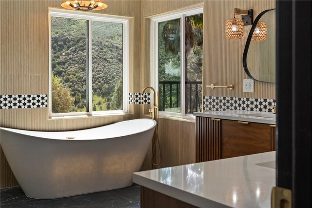115 Buckskin Rd, Bell Canyon, CA 91307 - bathroom featuring marble look tile flooring, vanity, healthy amount of natural light, and a freestanding bath