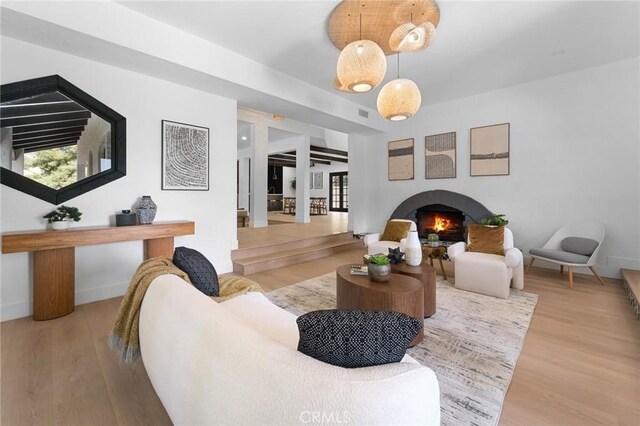 115 Buckskin Rd, Bell Canyon, CA 91307 - living area with a lit fireplace, wood finished floors, and baseboards