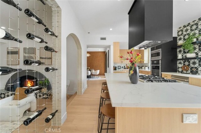 115 Buckskin Rd, Bell Canyon, CA 91307 - wine cellar featuring light wood-style floors, arched walkways, and recessed lighting