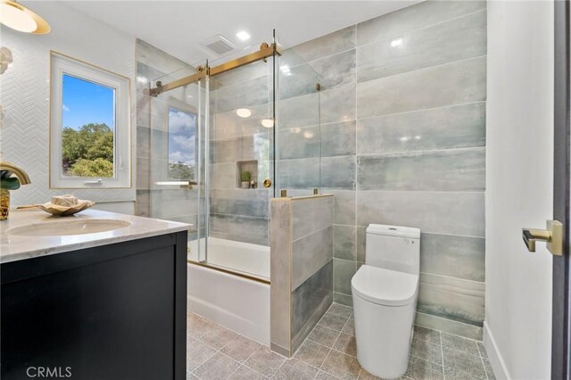 115 Buckskin Rd, Bell Canyon, CA 91307 - full bath with tile walls, vanity, shower / bath combination with glass door, toilet, and tile patterned flooring
