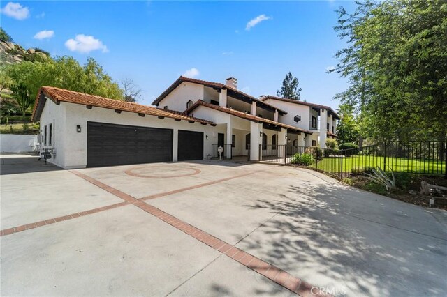 115 Buckskin Rd, Bell Canyon, CA 91307 - mediterranean / spanish home featuring stucco siding, concrete driveway, an attached garage, a chimney, and a tile roof