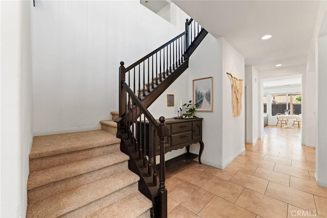 staircase featuring recessed lighting, tile patterned floors, and baseboards