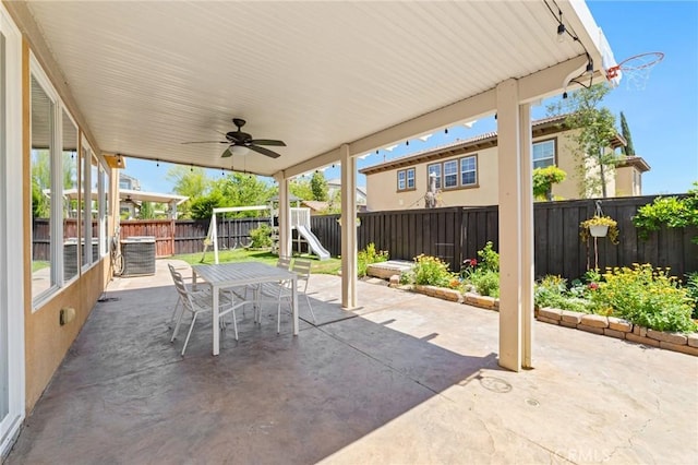 view of patio / terrace featuring central air condition unit, outdoor dining space, a fenced backyard, and ceiling fan