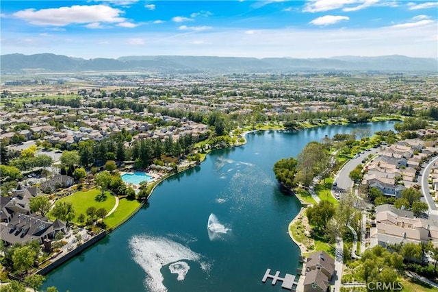 drone / aerial view with a residential view and a water and mountain view
