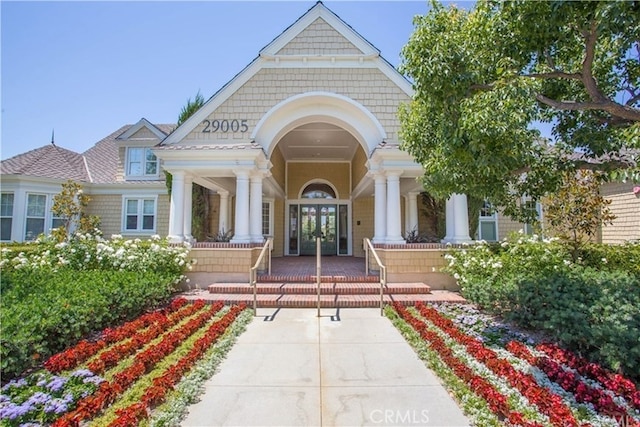 entrance to property featuring french doors and covered porch