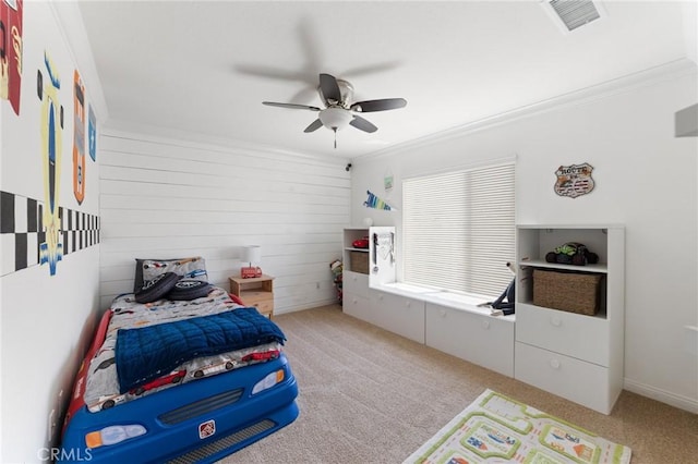bedroom with visible vents, ornamental molding, light carpet, and a ceiling fan