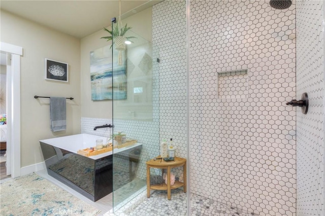 full bath featuring a walk in shower and baseboards
