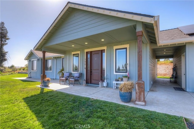 rear view of house with a lawn and board and batten siding