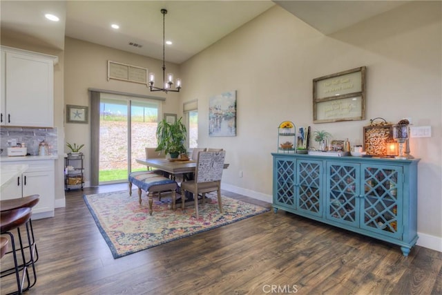 dining area featuring an inviting chandelier, baseboards, visible vents, and dark wood-type flooring