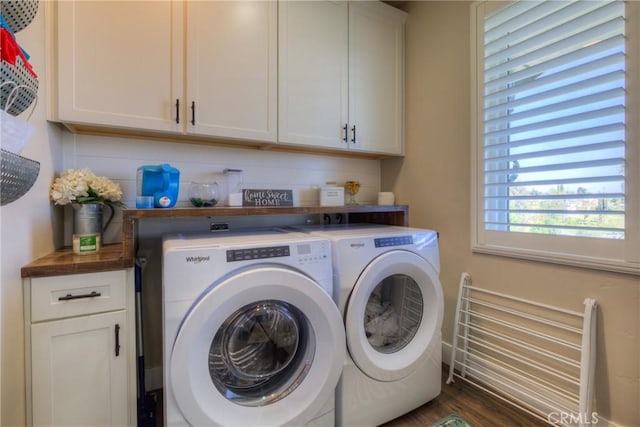 washroom featuring cabinet space, independent washer and dryer, and wood finished floors