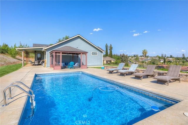 outdoor pool featuring a gazebo and a patio area