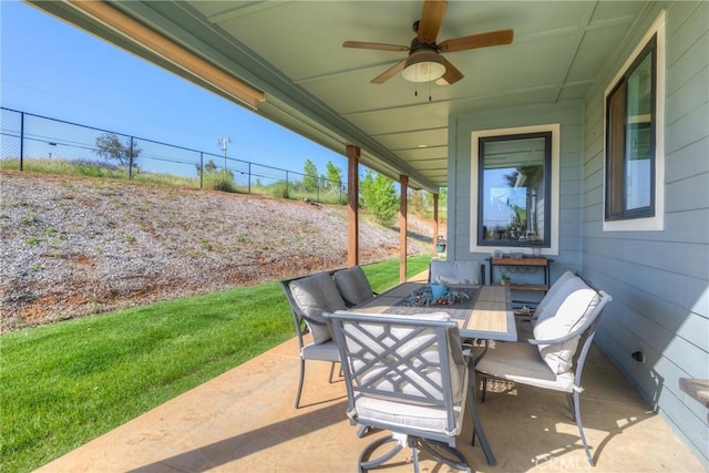 view of patio / terrace featuring fence, a ceiling fan, and outdoor dining area