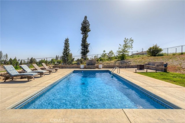 view of swimming pool with a fenced in pool, fence, and a patio