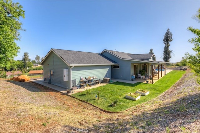 back of property featuring a yard and a patio