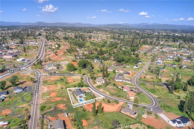 birds eye view of property with a mountain view