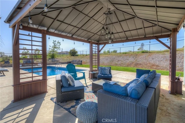 view of patio / terrace with a gazebo, outdoor lounge area, an outdoor pool, and a fenced backyard
