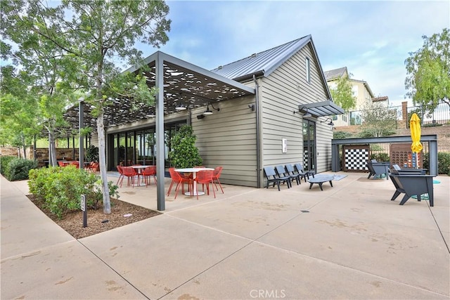 2454 Nova Way, Corona, CA 92883 - back of house with a patio, outdoor dining area, and metal roof