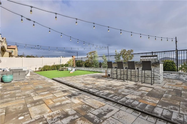 view of patio / terrace with a fenced backyard and outdoor dry bar