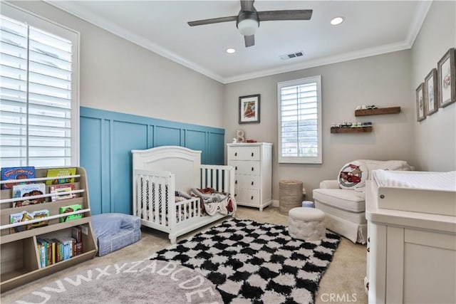 carpeted bedroom with recessed lighting, visible vents, a crib, and ornamental molding