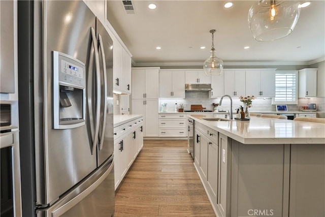 2454 Nova Way, Corona, CA 92883 - kitchen featuring stainless steel fridge, under cabinet range hood, a sink, backsplash, and light wood-type flooring