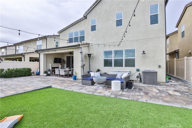 rear view of property featuring central air condition unit, fence, and a patio area