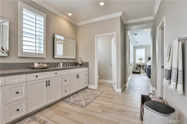 2454 Nova Way, Corona, CA 92883 - bathroom featuring vanity, wood finished floors, ornamental molding, toilet, and baseboards