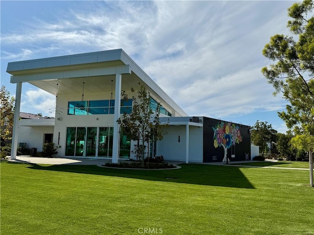 back of house with a lawn