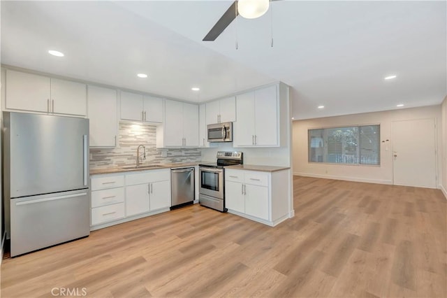 444 Obispo Ave Unit 201, Long Beach, CA 90814 - kitchen featuring appliances with stainless steel finishes, light countertops, white cabinets, a sink, and recessed lighting