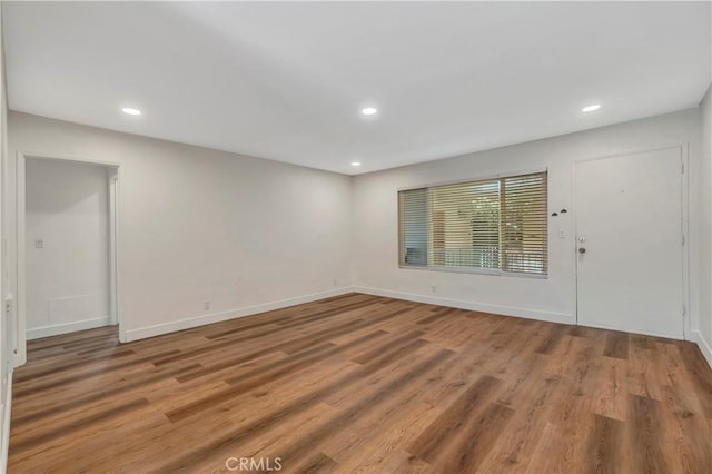 444 Obispo Ave Unit 201, Long Beach, CA 90814 - unfurnished room with wood finished floors, recessed lighting, and baseboards