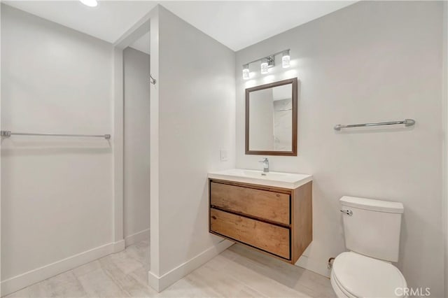 444 Obispo Ave Unit 201, Long Beach, CA 90814 - bathroom featuring toilet, baseboards, and vanity